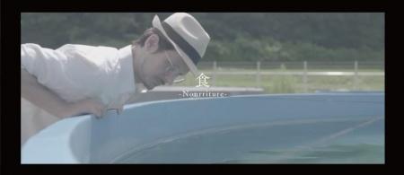 養殖場の水槽をのぞき込む男性の写真
