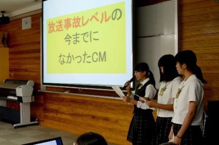 スクリーンにスライドを移しながら前に出て発表する3名の女子生徒の写真