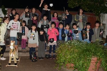 A group photo of children who attended an event outside at night