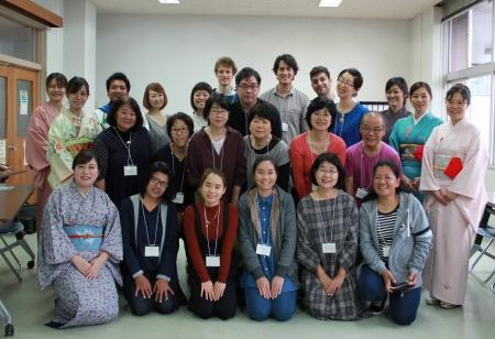 A group picture of participants of the event, including women in kimono, standing side by side with smiles on their faces