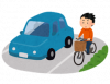 An illustration of a man riding a bicycle on a bicycle path set up beside a roadway